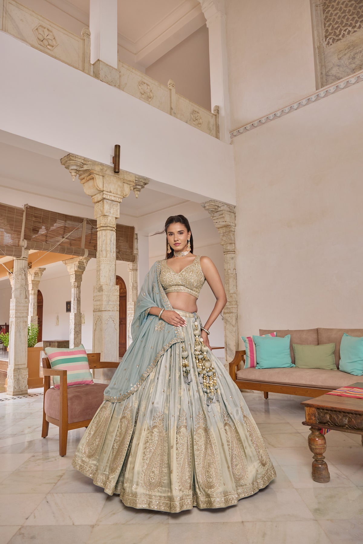 Priyanshi lehenga with blue dupatta draped across