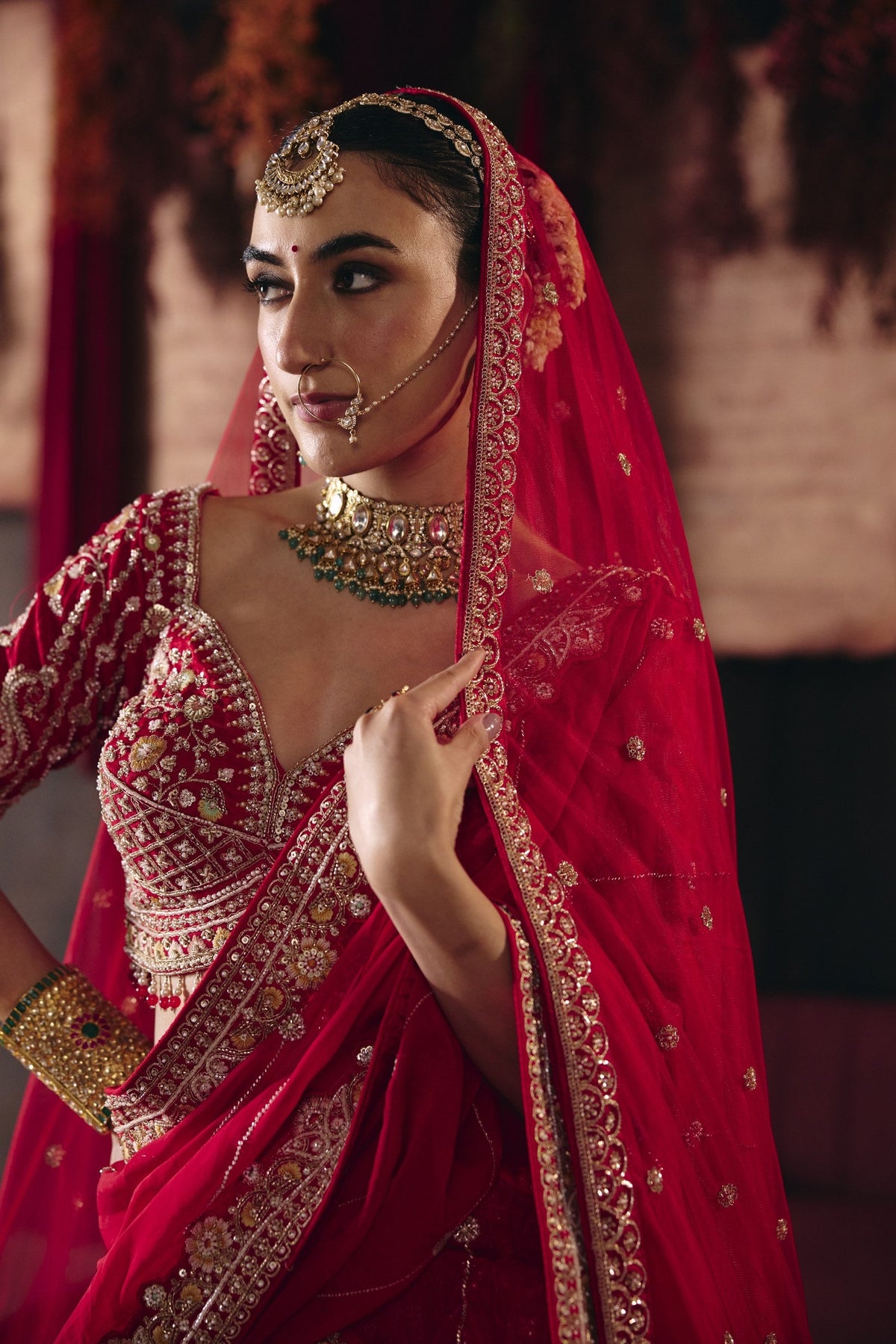 Crimson red bridal lehenga, blouse and dupatta close-up