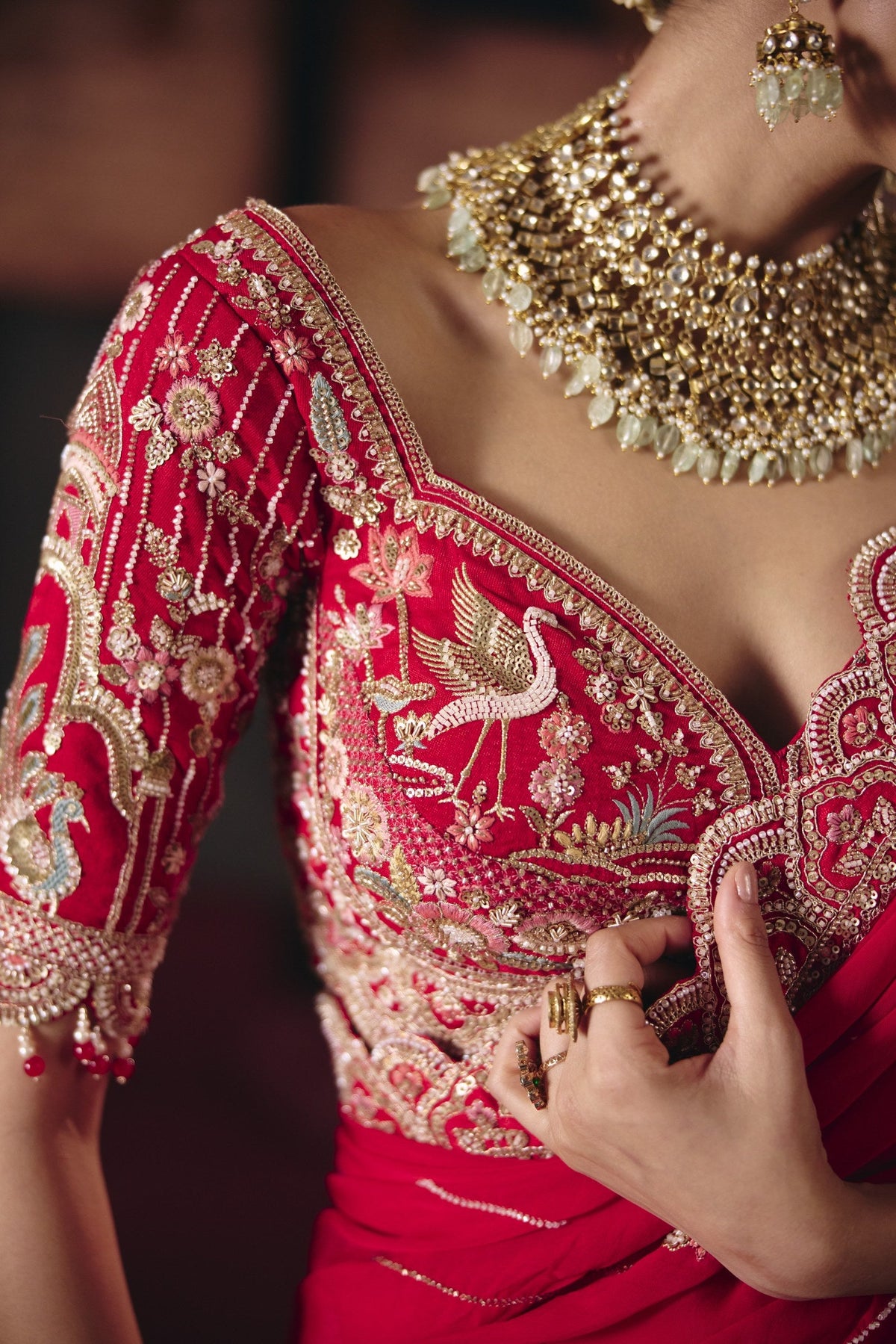 Red bird motif bridal lehenga, bird embroidery on blouse
