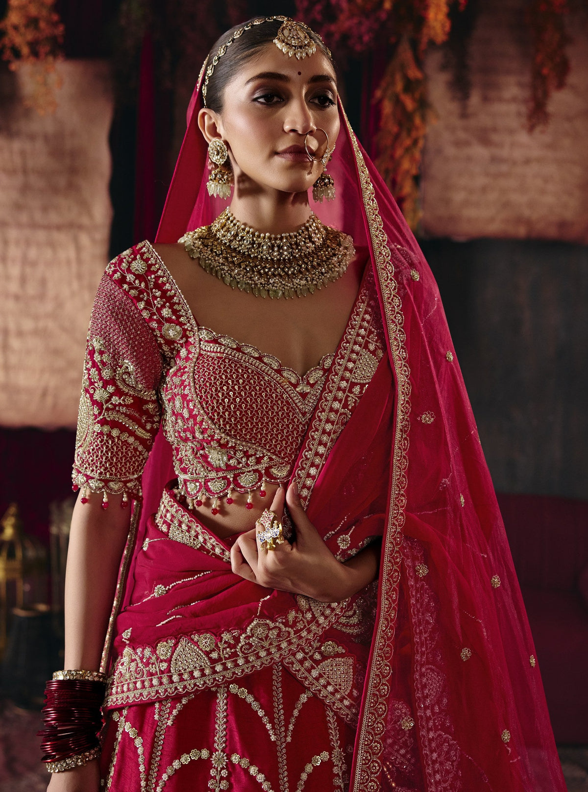 Cherry red bridal lehenga, embroidered blouse close-up