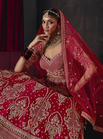 Cherry red bridal lehenga, seated view of skirt embroidery