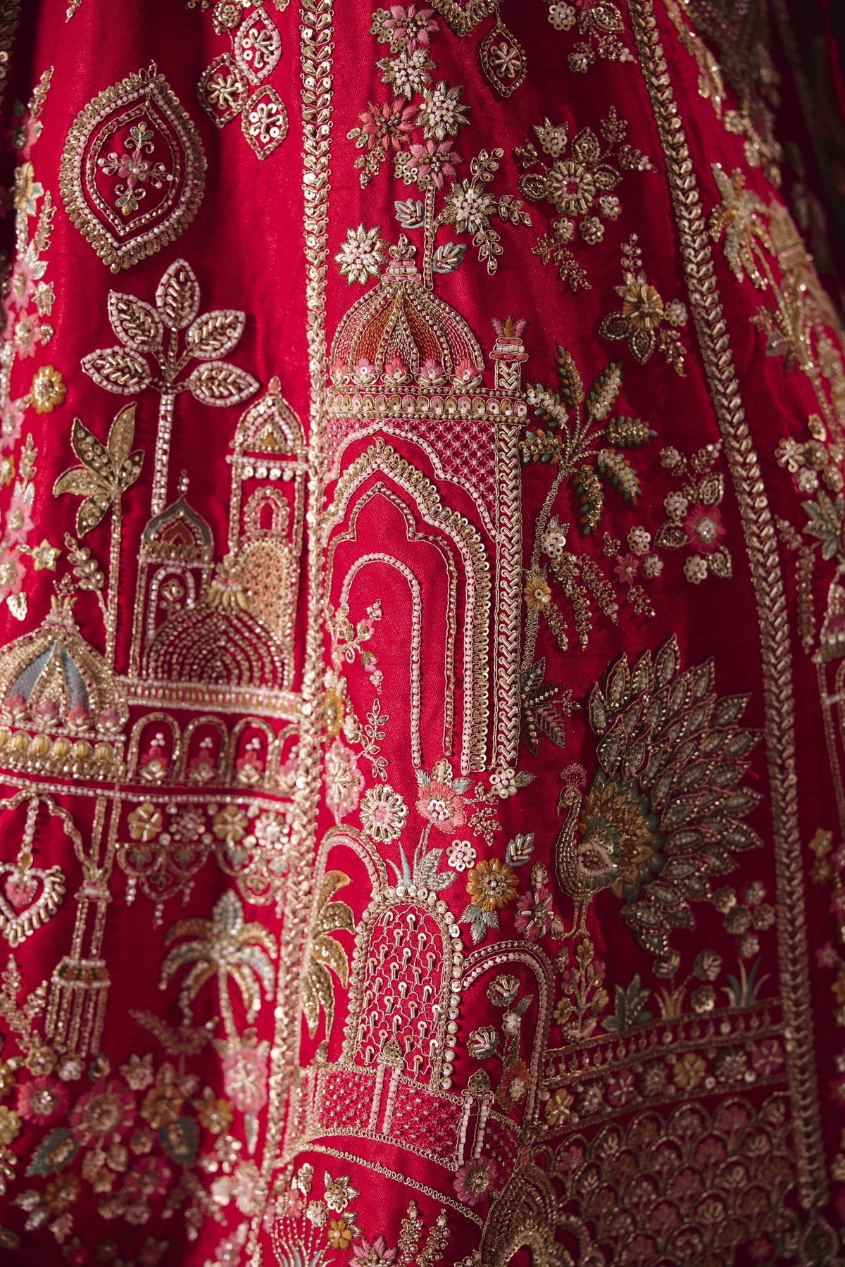 Red bridal lehenga, palace and peacock embroidery detail