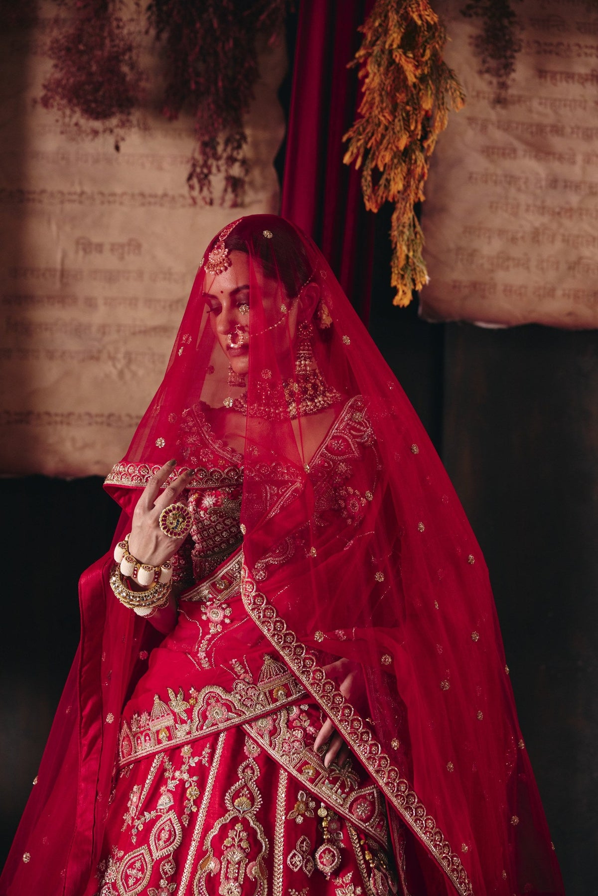 Red palace and peacock bridal lehenga with dupatta over the head