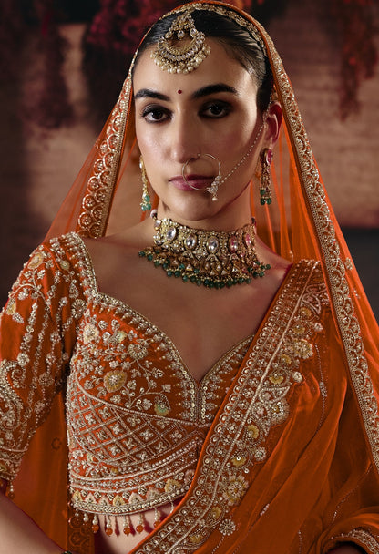 Rust orange bridal lehenga, embroidered blouse close-up