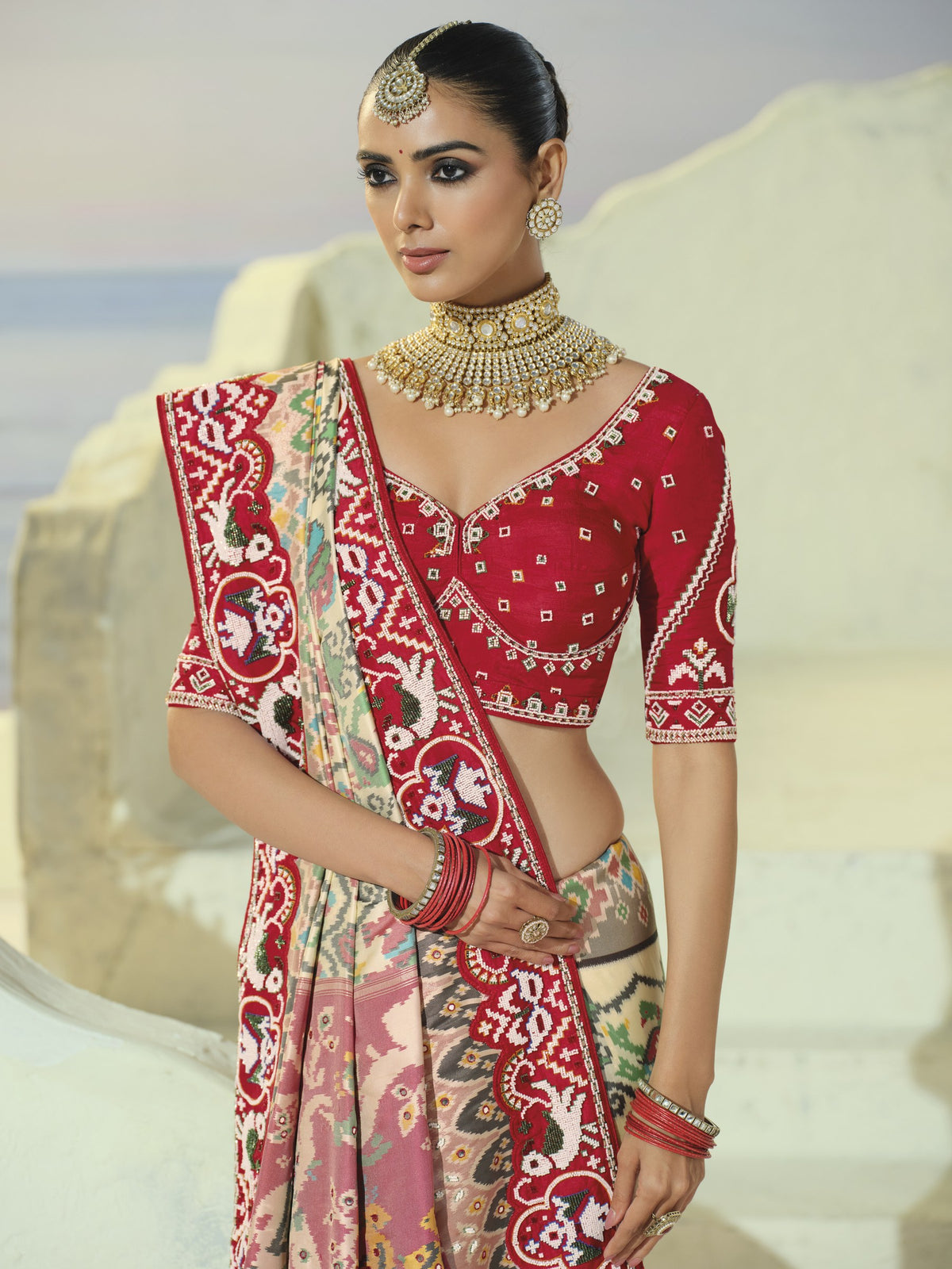 Cream patola saree, red blouse and border close-up
