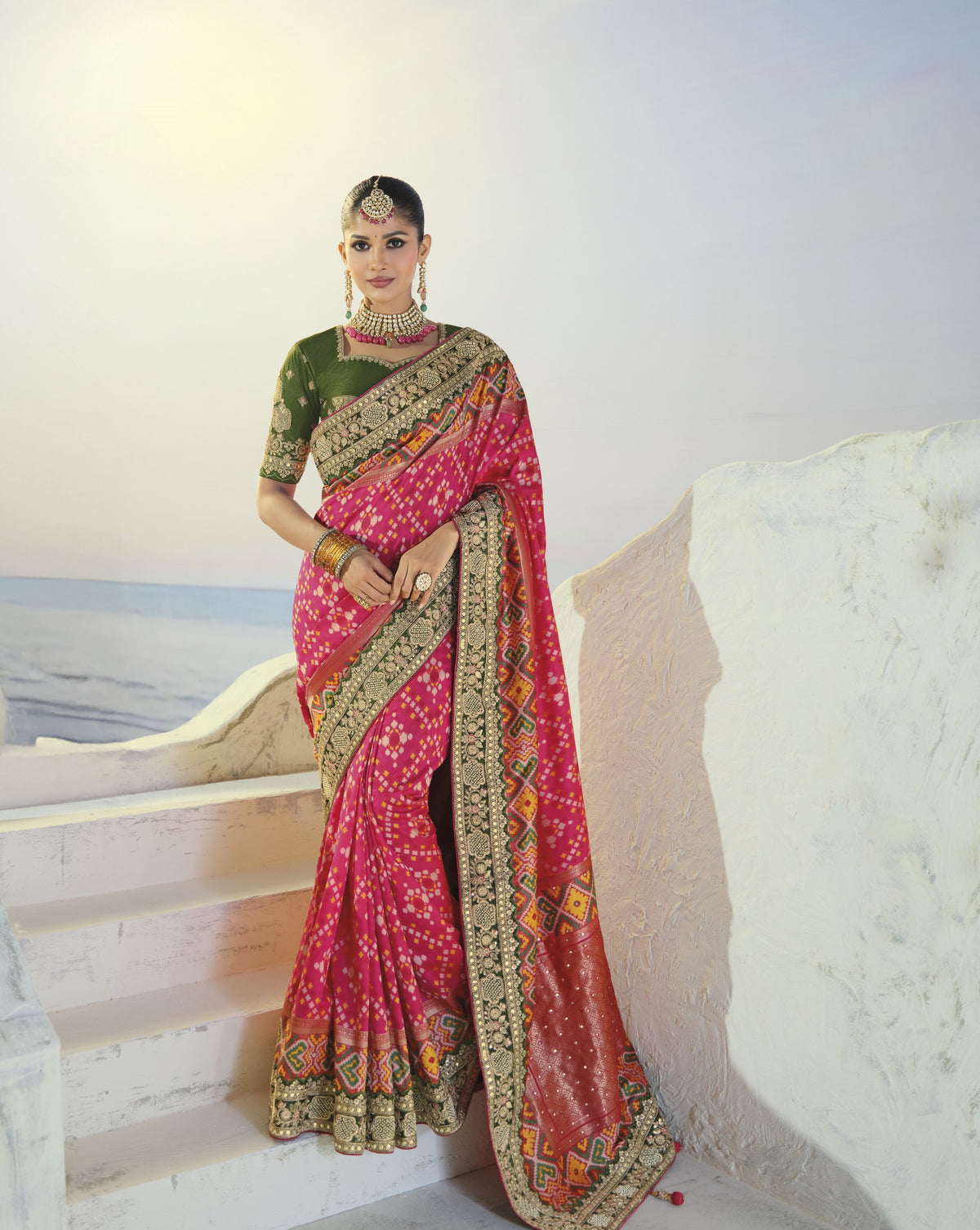 Rani pink patola saree with green border, full length