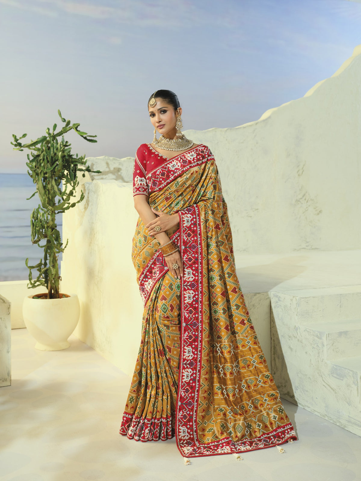 Chiku gold patola saree with red border, full length