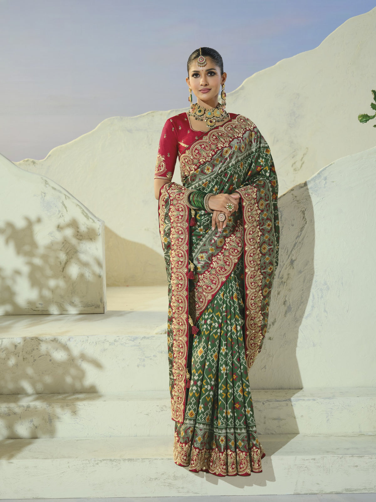 Bottle green patola saree with maroon border, full length
