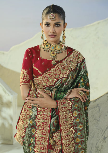 Bottle green patola saree, embroidered blouse and border close-up