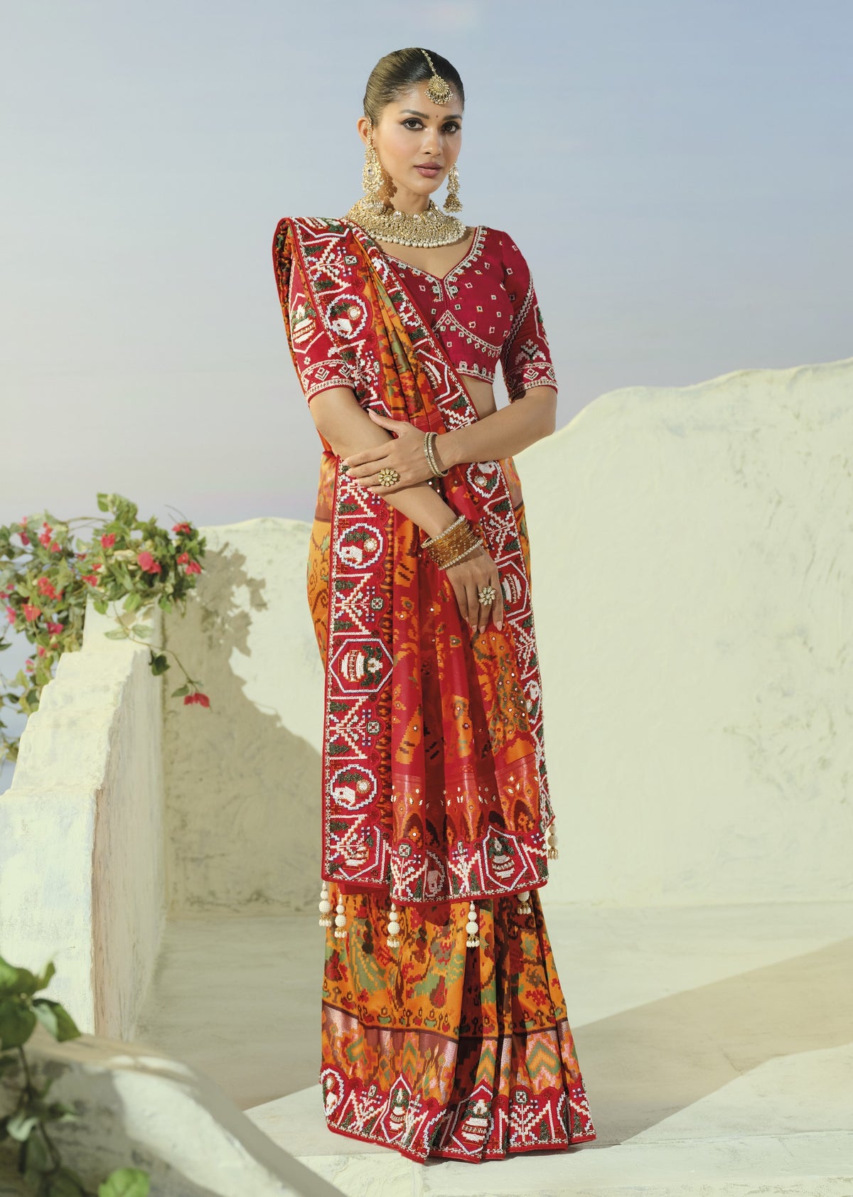 Orange and red patola saree, draped front view